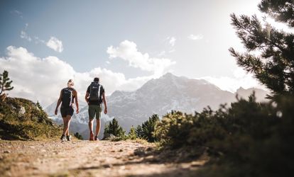 Coppia di escursionisti su un sentiero d'alta quota con vista sulle montagne