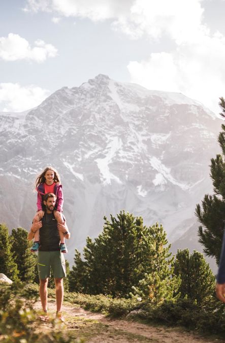 Family hiking with a view of snow-capped mountains