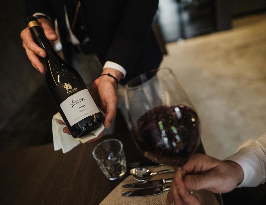 A waiter presents a bottle of wine