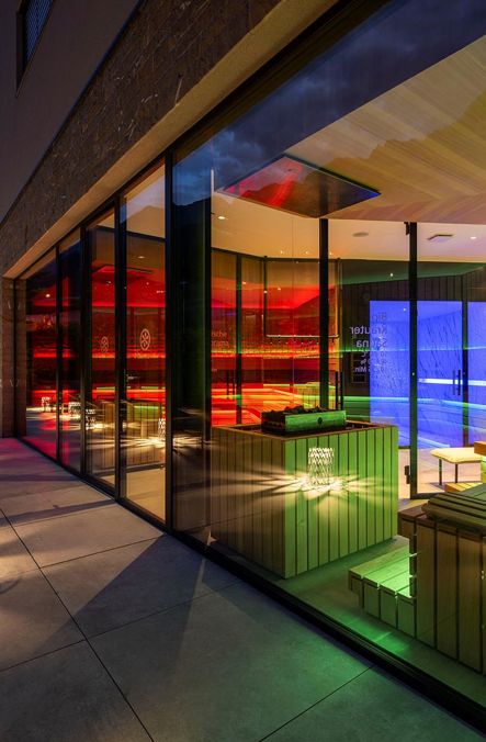 Sauna oasis in the evening with illuminated glass front